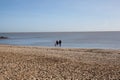 A young family on Clacton Beach in Essex in the UK