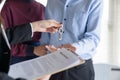 Young family couple getting house key from real estate agent after signed contract agreement home loan Royalty Free Stock Photo