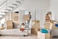 Young family couple with kid son unpacking boxes in new home on moving day. Royalty Free Stock Photo