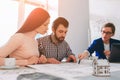 Young family couple purchase rent property real estate . Agent giving consultation to man and woman. Signing contract Royalty Free Stock Photo