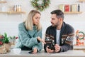 Young family couple quarreled over mobile phone and social networks, man and woman sad during the New Year holidays and Christmas Royalty Free Stock Photo