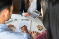 Young family couple signing home loan contract purchase agreement while property real estate agent show all prices on the Royalty Free Stock Photo