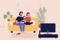 Young family couple sitting on sofa playing on TV gaming console video games in living room. Home leisure spare time