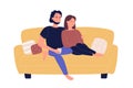 Young family couple sitting on sofa and watching TV movie in living room. Home leisure spare time, people resting and Royalty Free Stock Photo