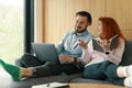 Young family couple working together, using laptop and notebook at Scandinavian living room Royalty Free Stock Photo