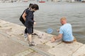 Young family crab fishing on the quay side in Conwy.