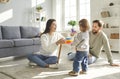 Young family with a daughter playing an educational pyramid game at home together. Royalty Free Stock Photo