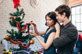 Young family decorating Christmas tree at home Royalty Free Stock Photo