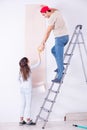 The young family doing renovation at home with new wallpaper Royalty Free Stock Photo
