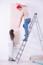 The young family doing renovation at home with new wallpaper Royalty Free Stock Photo