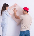 Young family doing renovation at home with new wallpaper Royalty Free Stock Photo