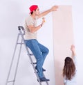 Young family doing renovation at home with new wallpaper Royalty Free Stock Photo