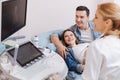 Young family enjoying appointment at the sonography cabinet