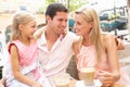 Young Family Enjoying Cup Of Coffee