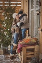 Young family enjoying their holiday time together, decorating Christmas tree outdoors in warm clothes Royalty Free Stock Photo