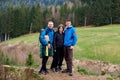 Young family enjoying their holidays in a national park. Caucasian family walking down a mountain trail and having fun Royalty Free Stock Photo