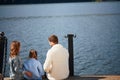 Happy family with daughter fishing in pond in fall Royalty Free Stock Photo