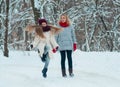 Young family have fun on the ice area in a snowy frozen park Royalty Free Stock Photo