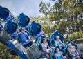 Young family having fun riding a rollercoaster at a theme park Royalty Free Stock Photo