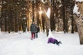 Young family having fun in winter forest Royalty Free Stock Photo