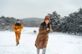 Young family having fun in winter snowy forest Royalty Free Stock Photo