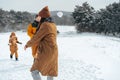 Young family having fun in winter snowy forest Royalty Free Stock Photo