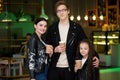 Young family having time in a cafe after shopping. Mom, dad, little daughter drink tea and cafe. Royalty Free Stock Photo