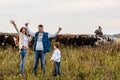 Young family and a herd of cows Royalty Free Stock Photo