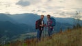 Young family hiking together on mountains nature sunset. Couple talk on hiking. Royalty Free Stock Photo