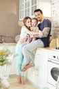 Young family at home in the morning on a day off. Married couple and their little baby baby in her arms. Joyful and happy faces Royalty Free Stock Photo