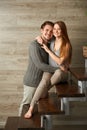 Young family hugging while sitting on stairway