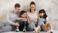 Young family with kids have fun using cellphone together Royalty Free Stock Photo