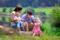 Young family with kids hiking at a lake