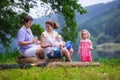 Young family with kids hiking at a lake