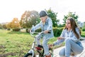 Young family, little boy 3-5 years old, mother woman, learn to ride bike, in summer in city park. Weekend rest on sports Royalty Free Stock Photo