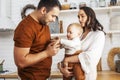 Young family with little cute son on kitchen in morning happy smiling, lifestyle people concept