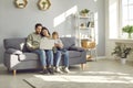 Young family looking at laptop together at home. Royalty Free Stock Photo