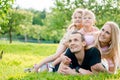 Young family lying on grass in countryside Royalty Free Stock Photo