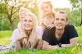 Young family lying on grass in countryside Royalty Free Stock Photo