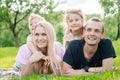 Young family lying on grass in countryside Royalty Free Stock Photo