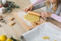 Young family making cookies at home. Making a gingerbread cookie with the kids at christmas time Royalty Free Stock Photo