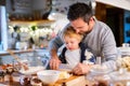 Young family making cookies at home. Royalty Free Stock Photo