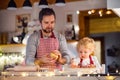 Young family making cookies at home. Royalty Free Stock Photo