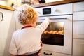 Young family making cookies at home. Royalty Free Stock Photo