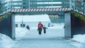 A young family of mother and two children skating on the ice