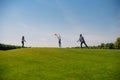 Young family with one child playing with flying disk outdoors Royalty Free Stock Photo