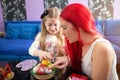 Young family painting Easter eggs -Mother and daughter Royalty Free Stock Photo