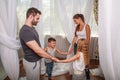 Young parents with children daughter and son have fun at home fooling around, playing and spending time together Royalty Free Stock Photo