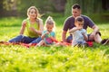 Family in park -Male and female child blow soap bubbles outdoor