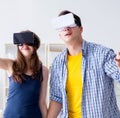 Young family playing games with virtual reality glasses Royalty Free Stock Photo